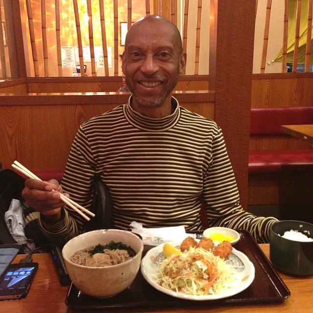 Lloyd seated at a table with a meal